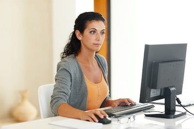 girl-sitting-painfree-at-desk-who-has-had-pain-relief-sitting-